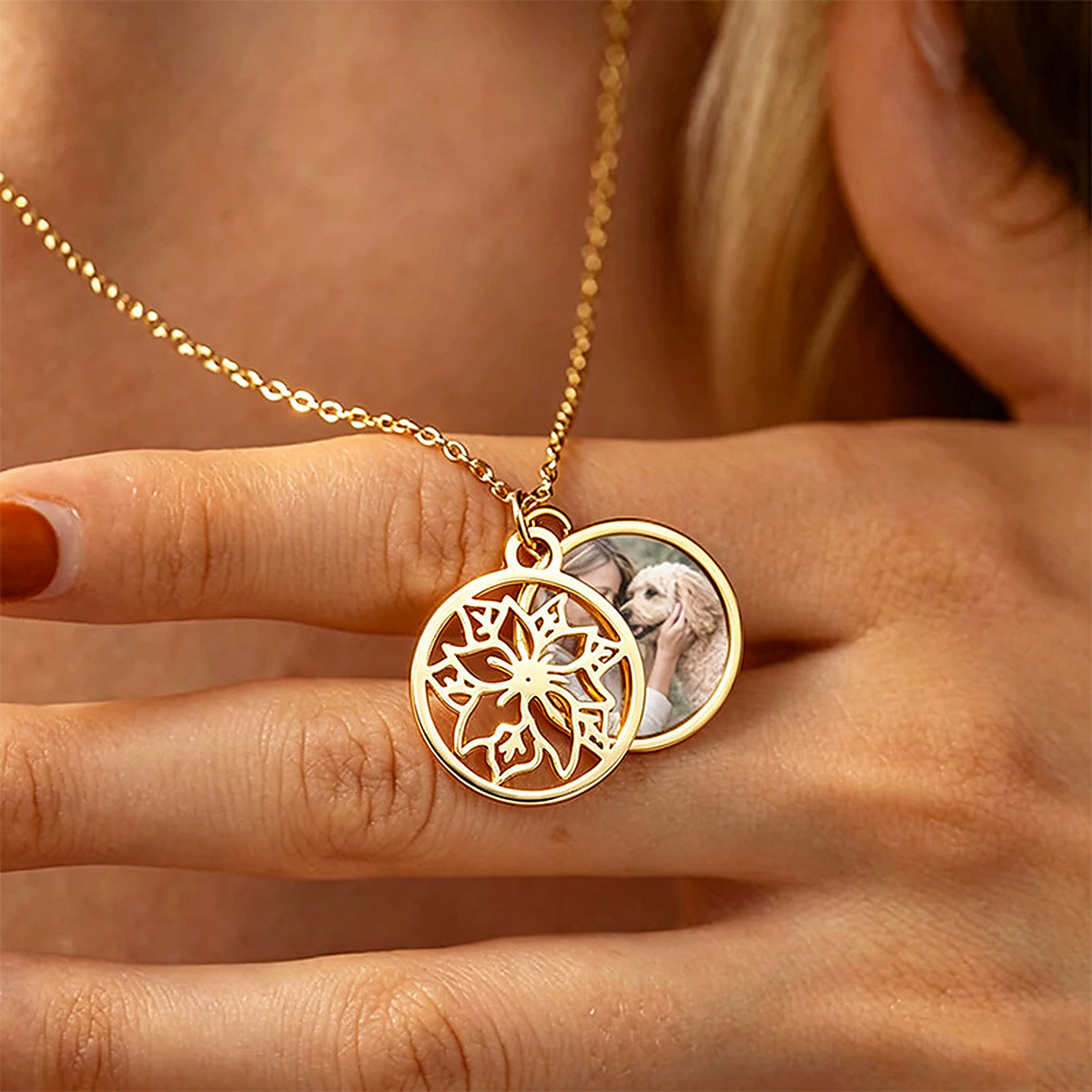 Gold-tone birth flower necklace worn open to reveal a custom family photo
