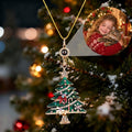 Personalized cat photo projection necklace with a jeweled Christmas tree pendant displayed on a holiday tree