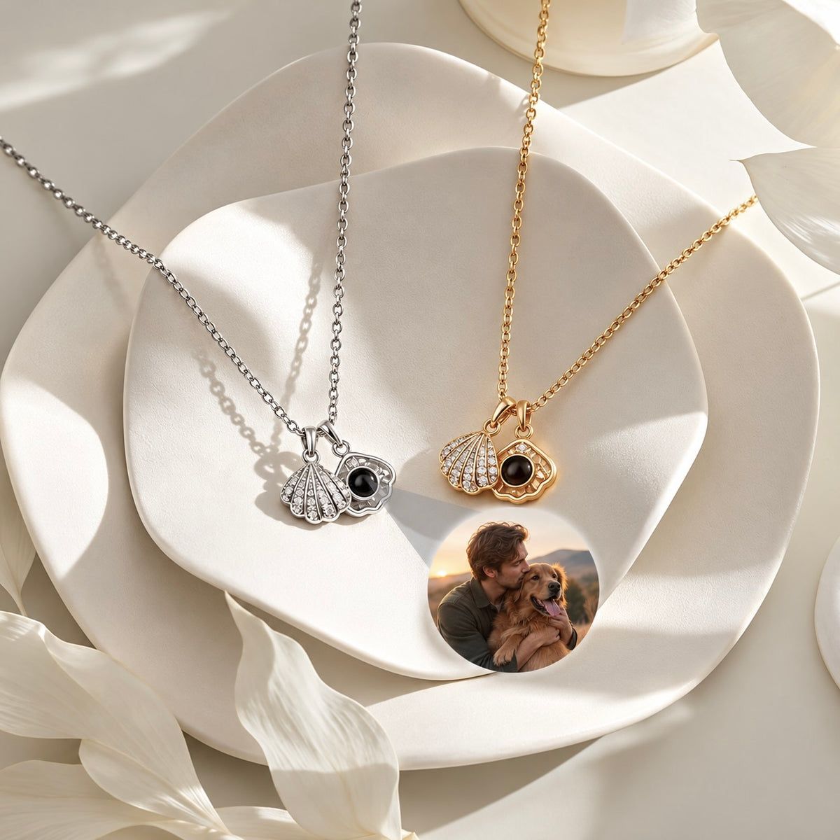 Gold-tone and silver-tone personalized shell necklaces projecting a photo of a person with a dog