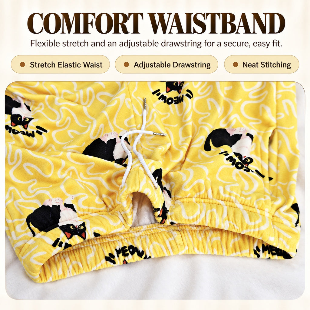 Close-up of the yellow cat-print pajama pants with elastic waistband and adjustable white drawstring