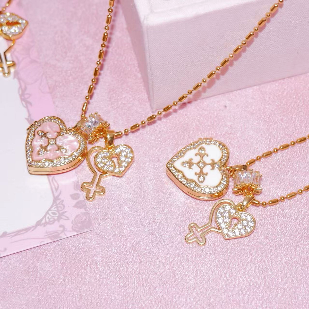 Pink and white custom heart photo locket necklaces with gold-tone chains and zircon key charms