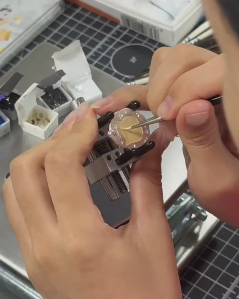 Video demonstrating the meticulous hand-painting process of a custom cat portrait on a copper pendant necklace, luxury bespoke jewelry by Memopaw.