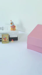 Unboxing video of a custom pet portrait gift set, showcasing a personalized pet photo mug, travel tumbler, and phone case inside a pink gift box.