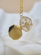 Open gold personalized pet memorial locket necklace featuring a detailed angel design