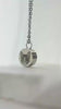 Video showing a personalized pet hair memorial necklace with custom portrait engraving