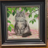 Artist hand-painting fine fur and texture details on canvas for a custom framed pet oil painting.