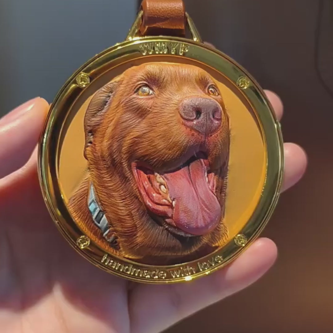 Close-up video of a handcrafted custom 3D leather pet portrait pendant, showcasing the detailed raised relief and hand-painted dog fur texture.