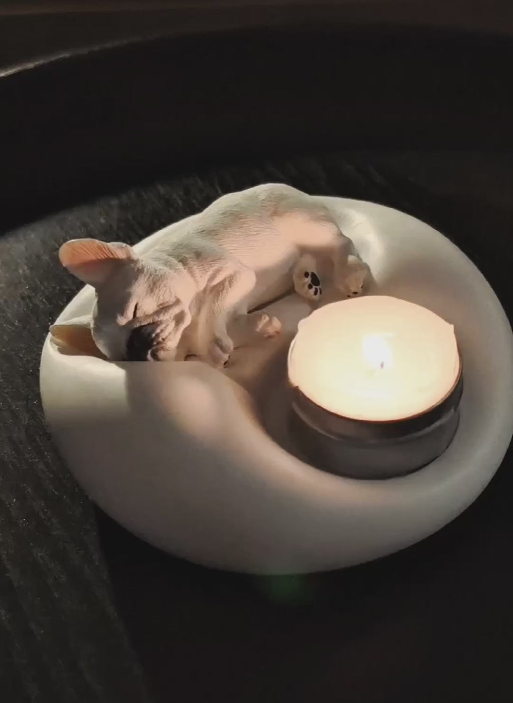 Video preview of a matte white plaster sleeping French Bulldog candle holder and jewelry trinket tray with a lit tealight candle, cozy pet-themed home decor by Memopaw.Small French Bulldog tray for rings earrings and tealights