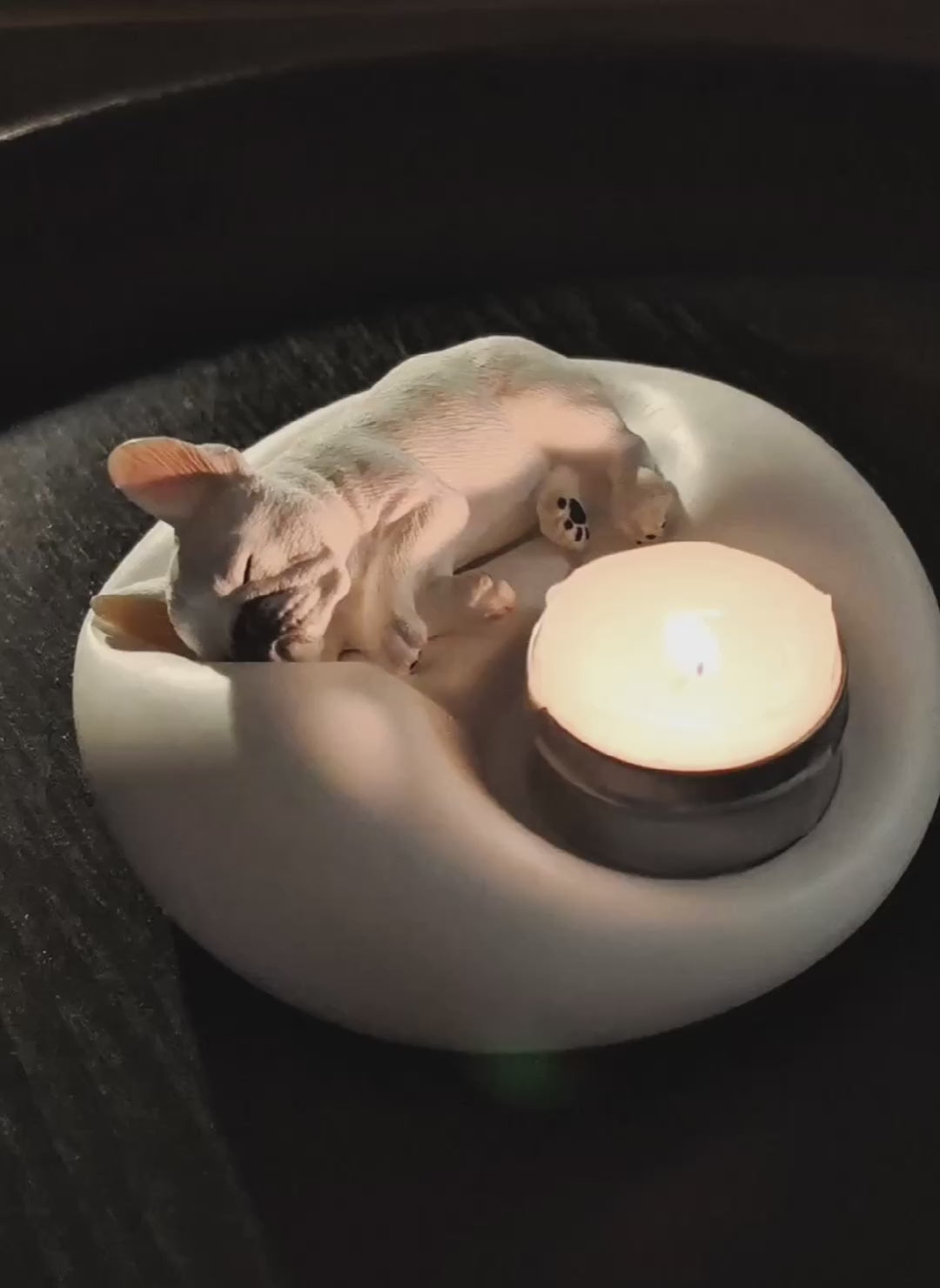 Video preview of a matte white plaster sleeping French Bulldog candle holder and jewelry trinket tray with a lit tealight candle, cozy pet-themed home decor by Memopaw.Small French Bulldog tray for rings earrings and tealights