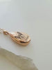Video showing a personalized rose-gold pet urn necklace engraved with a dog portrait