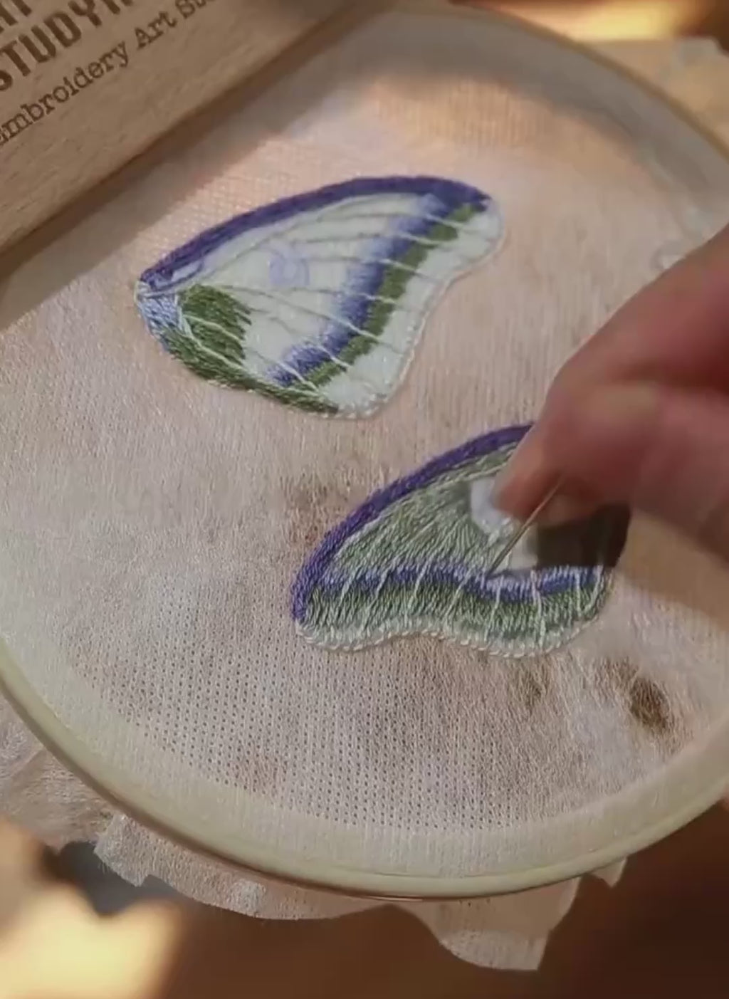 Video showcasing the detailed hand-embroidery process and realistic textile texture of a custom silk butterfly brooch pin by Memopaw.Hand embroidery process for a custom butterfly brooch