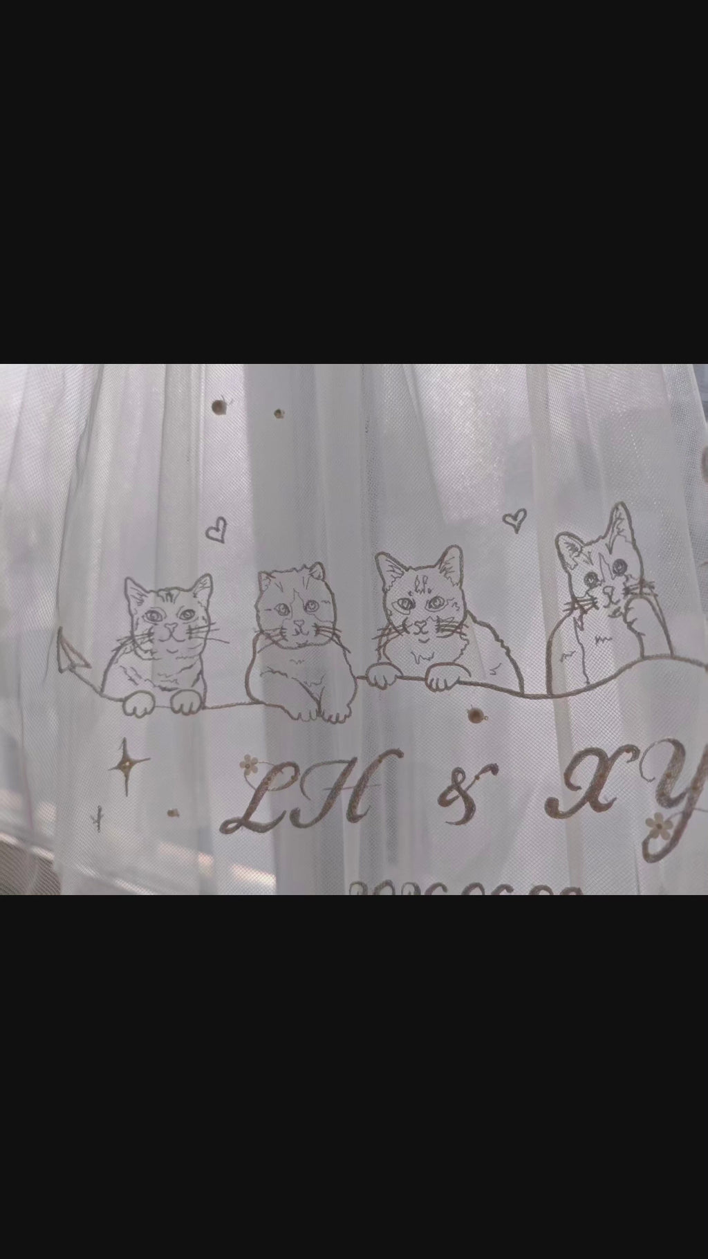Close-up video of a luxury bridal wedding veil featuring intricate hand-stitched custom dog embroidery, perfect pet-themed bridal wear for dog moms.
