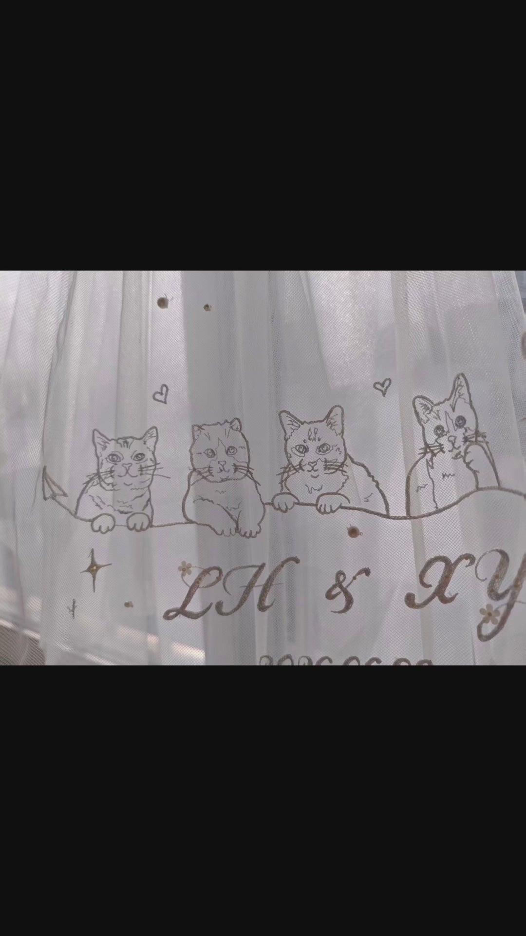 Close-up video of a luxury bridal wedding veil featuring intricate hand-stitched custom dog embroidery, perfect pet-themed bridal wear for dog moms.