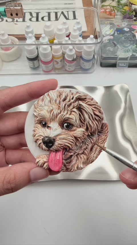 Video showing an artist hand-painting a custom 3D relief leather keychain of a curly-haired puppy, showcasing the detailed craftsmanship behind Memopaw personalized pet gifts.