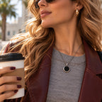 Model wearing a silver temperature-sensitive photo necklace while the round pendant appears black