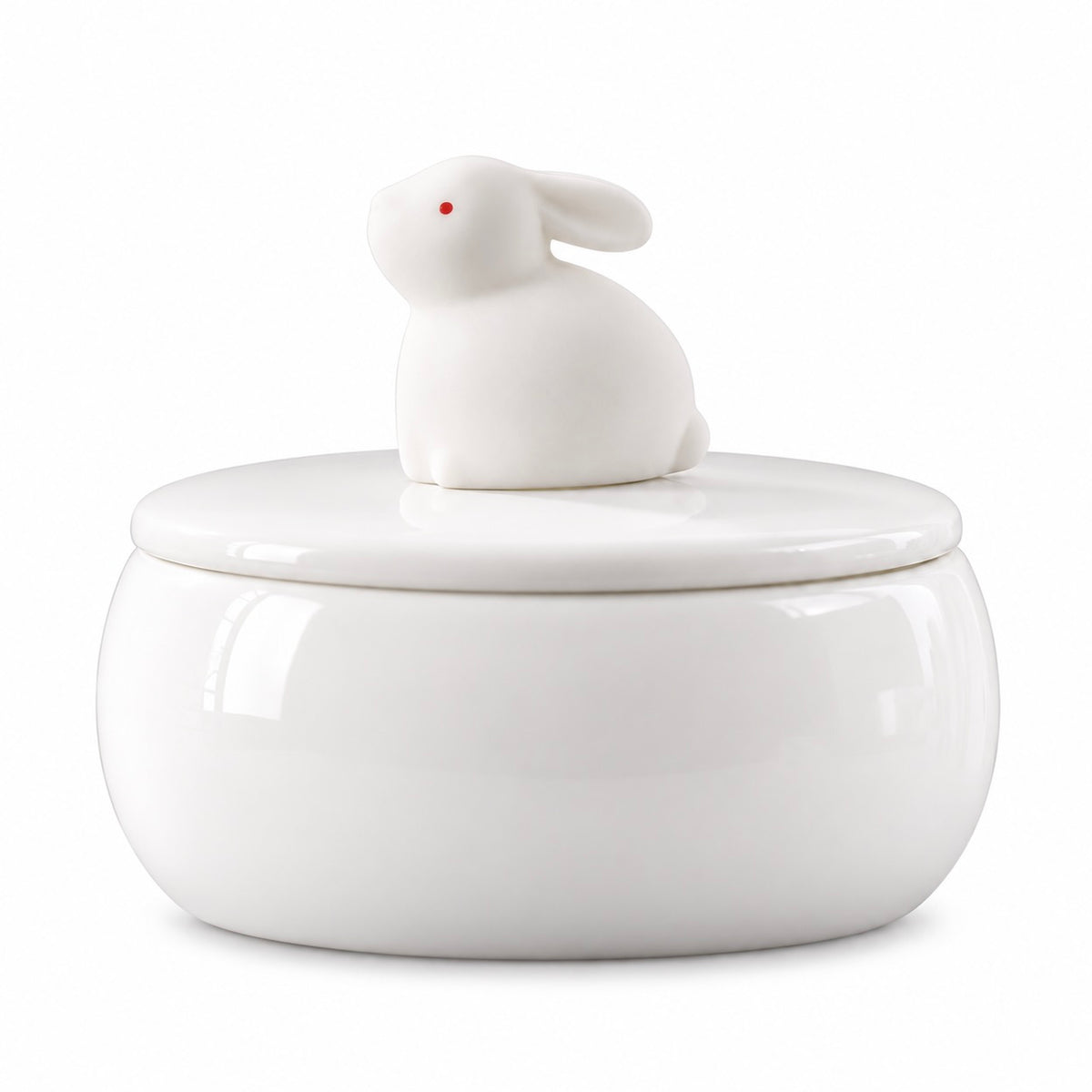 White ceramic memorial urn with a sitting rabbit figure and small red eye on the lid