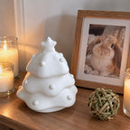 Tree-shaped pet memorial urn displayed beside a framed rabbit photo and remembrance toy