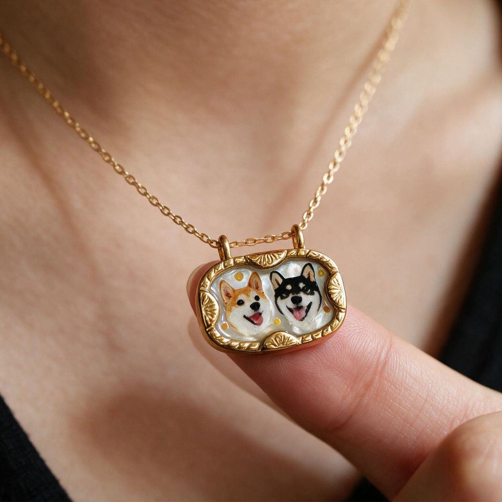 Gold-tone mother-of-pearl necklace featuring two custom dog portraits in a vintage-style frame