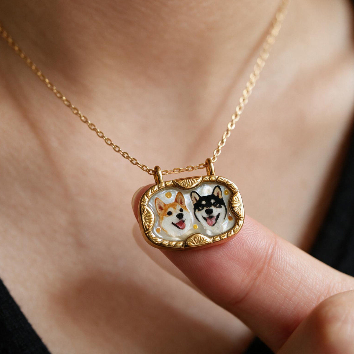 Gold-tone mother-of-pearl necklace featuring two custom dog portraits in a vintage-style frame