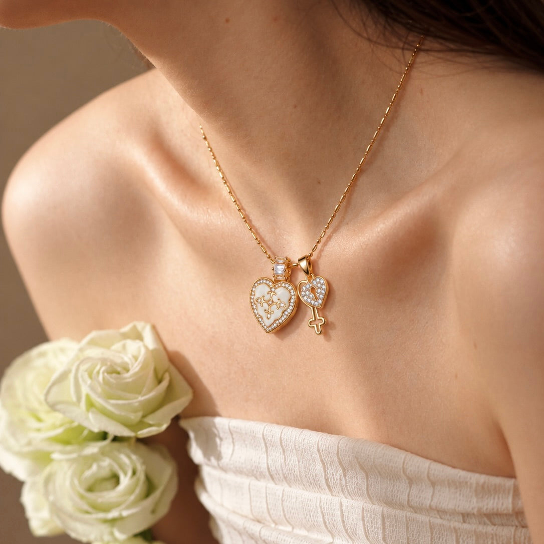 Model wearing a white heart photo locket necklace with zircon border and matching key charm