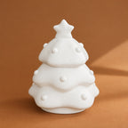 Front view of the white speckled tree-shaped pet memorial urn on a warm brown background
