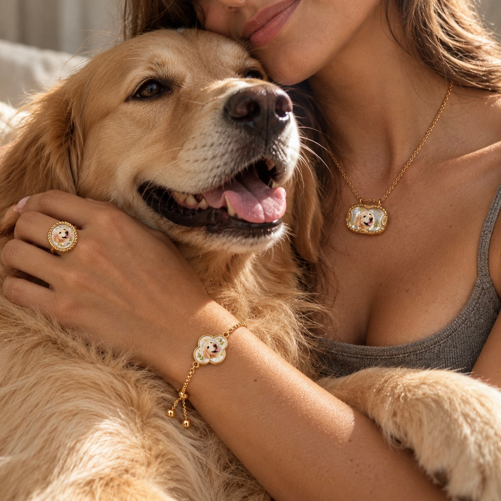 Woman holding a golden retriever while wearing matching pet portrait necklace, ring and bracelet