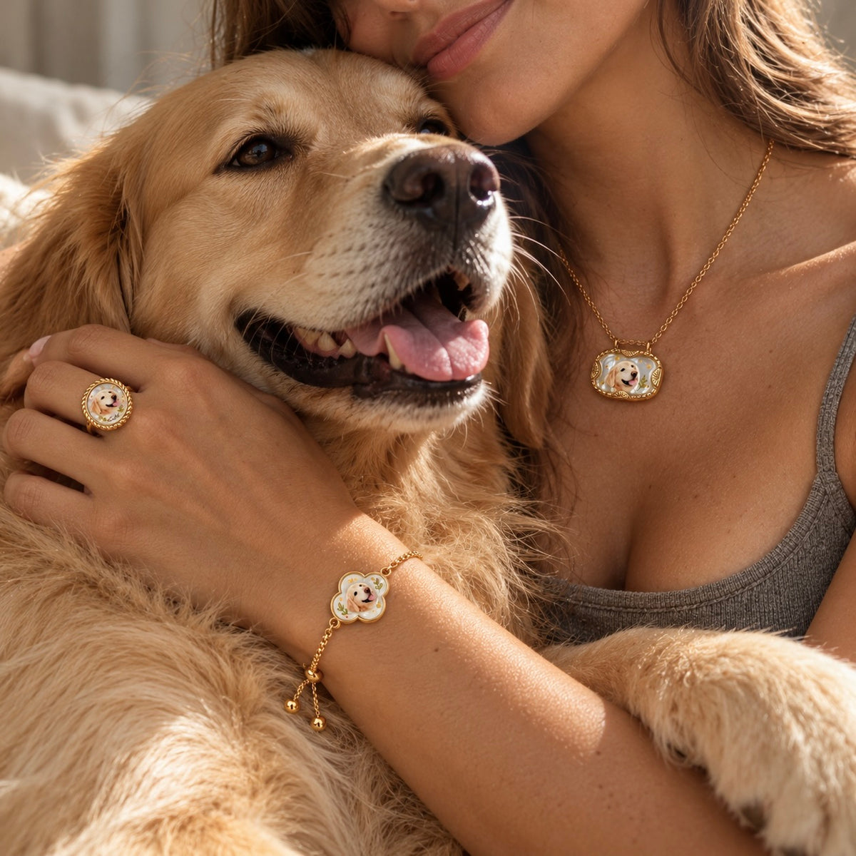 Woman holding a golden retriever while wearing matching pet portrait necklace, ring and bracelet