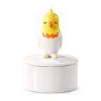 Ceramic bird memorial urn with a yellow, white and orange bird figure with closed eyes on the lid